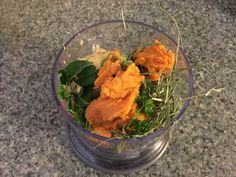 a glass bowl filled with food on top of a counter