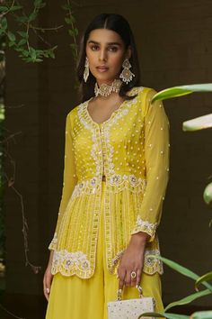 Yellow long sleeves short peplum jacket with floret embroidery using pearl, sequin and cutdana highlights. Paired with a flared plain sharara. - Aza Fashions Designer Wear Long Sleeve Sets With Gota Work, Designer Long Sleeve Sets With Gota Work, Long Sleeve Choli With Gota Work, Yellow Long Sleeve Choli For Eid, Yellow Long Sleeve Choli For Wedding, Fitted Long Sleeve Sharara With Gota Work, Peplum Jacket, Aza Fashion, Yellow