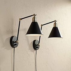 two lamps on the wall next to each other