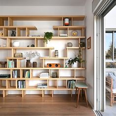 a living room filled with lots of wooden shelves