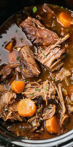 a slow cooker filled with beef stew and carrots