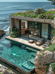 an outdoor swimming pool next to the ocean