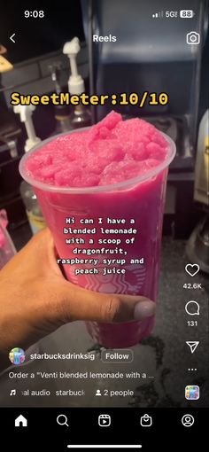 someone is holding up a pink drink in front of the camera and it's caption