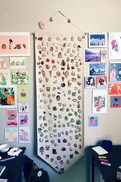 a wall with many pictures and magnets attached to it, along with a computer desk