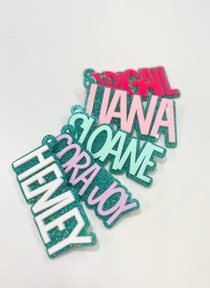 three stickers that say i love hawaii and some type of words in pink, green, and blue