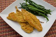 fried fish and green beans on a white plate