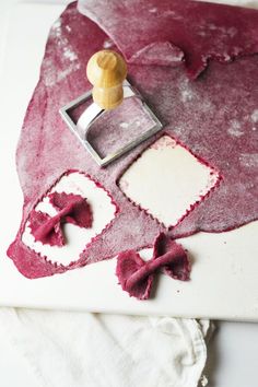 a close up of a cake with red frosting and a stamper on it