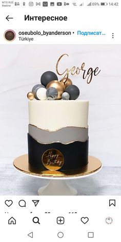 a white and black cake with gold decorations