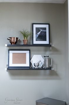 two shelves with pictures and other items on them