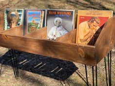 a wooden rack with books on it in the grass