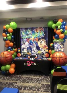 the balloon arch is decorated with basketballs, balloons and other sports related items for an event