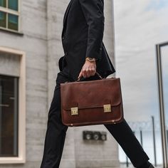 The No.2 briefcase fits in wherever you do business. The impressive premium leather messenger briefcase combines a timeless design with modern functionality. The No.2 is handcrafted in Northern Italy from the finest premium Italian full-grain vegetable-tanned cow leather and is available in several classic colors. The interior is lined with hard-wearing cotton canvas and convenient compartments make it easy to carry your everyday and business essentials fully organized. Comfortably pack up to a Briefcase Photoshoot, Cognac Satchel With Smooth Grain For Work, Classic Business Shoulder Bag With Leather Handles, Modern Cognac Briefcase With Top Handle, Modern Cognac Briefcase With Smooth Grain, Cognac Leather Briefcase For Office, Formal Briefcase With Leather Top Handle, Cognac Briefcase With Leather Handles For Office, Formal Briefcase With Leather Handles And Top Handle