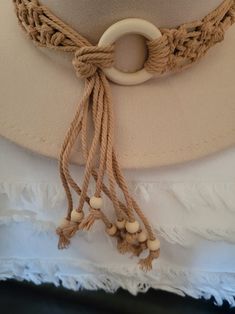 a white hat with some tassels attached to it