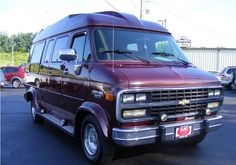 a maroon van parked in a parking lot