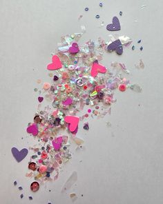 many hearts and confetti are scattered on the table