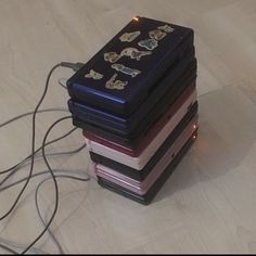 a stack of books sitting on top of a wooden floor next to a computer mouse