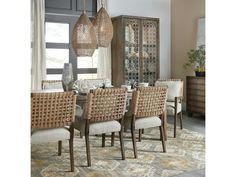 a dining room table with chairs and a china cabinet in the back ground next to it