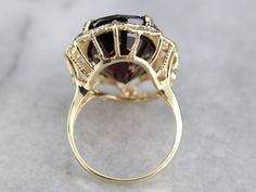 Timeless and elegant, this ring features a low profile and sweeping lines. Crafted of detailed yellow gold, this vintage ring has a stunning center, easy to wear and comfortable on the hand. The crimson-hued garnet gem has a perfect cutting and is well proportioned to the golden frame. Metal: 10K Yellow Gold Gem: Pyrope Garnet 21.73 Carats Gem Measurements: 18.2 x 14.1 mm, Oval Ring Size: 7.50 Marks: "ATC 10K" Stamped on the inside band Yellow Gold Sapphire Ring, Ruby Ring Vintage, Pyrope Garnet, Filigree Ring Gold, Garnet Gem, Golden Frame, Diamond Collection, Cameo Ring, Right Hand Rings