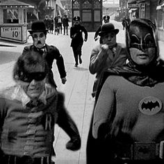 black and white photograph of people dressed up as batman