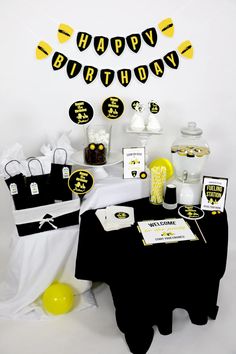 a birthday party with black and yellow decorations