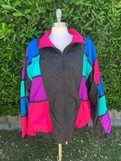 "Super fun, bright and colorful vintage circa 1980s-1990's bomber jacket. Picasso inspired nylon windbreaker. Bold statement piece to add to anyone's collection. Excellent vintage condition. Size: XL Length: 25\" Width: 25\" Sleeve: 21\" All approx measurements are taken laying flat. ✨Lighting in pictures may vary.✨ Please feel free to message with any questions before purchasing. All sales are final. No refunds or exchange are available.  Vintage sizes tend to run small, so please check measurements.  Unlike brand new merchandise, vintage and antique items will often show signs of wear and aging." 90s Multicolor Hooded Outerwear, 90s Style Multicolor Windbreaker For Spring, Retro Multicolor Windbreaker For Streetwear, Retro Multicolor Windbreaker For Winter, 90s Multicolor Outdoor Outerwear, Retro Multicolor Winter Windbreaker, 90s Inspired Multicolor Long Sleeve Outerwear, Spring Multicolor Nylon Windbreaker, Vintage Multicolor Windbreaker For Spring