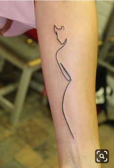 a woman's arm with a small tattoo on the left side of her body