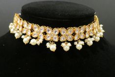 This is a beautiful set with intricate details and comes with a matching set of earrings. The finish is in a beautiful gold and is a simple yet elegant necklace that can be paired with any outfit. Wedding Choker With Gota Work For Diwali, Festive Wedding Choker With Gota Work, Festive Wedding Gota Work Choker, Bollywood Style Gota Work Choker For Wedding, Bollywood Style Wedding Choker With Gota Work, Luxury Meenakari Choker For Wedding, Gold Meenakari Bridal Choker Necklace, Gold Meenakari Choker Necklace, Bollywood Style Hand-set Gold Choker