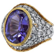 A deep, periwinkle blue tanzanite weighing 8.25 carats is featured in this beautiful Florentine inspired ring set with round brilliant cut diamonds. The intricately pierced and engraved details of this ring display the skills required to create such a stunning piece of jewelry. Such fine craftsmanship is seldom seen today. Handmade in Italy of 18k yellow and white gold. Ring size 7 Complimentary sizing as needed Tanzanite, 14.00 x 10.30 x 8.6mm, 8.25 carats 36 round brilliant cut diamonds, .96 c Deep Periwinkle, Dome Rings, Vintage Cocktail Ring, Tanzanite Diamond, Gem Diamonds, Blue Tanzanite, Coral Jewelry, Periwinkle Blue, Domed Ring