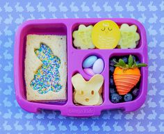 a purple plastic tray filled with food on top of a table