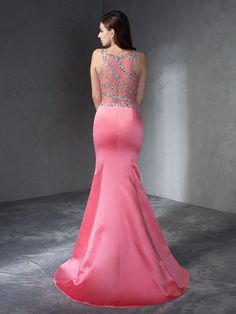 a woman in a long pink dress looking back