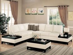 a living room filled with white furniture and lots of windows