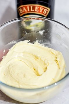 a bowl filled with batter next to a bottle of bailey's