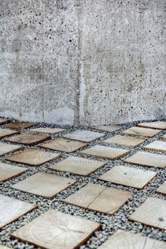 a red fire hydrant sitting on top of a tiled floor next to a wall