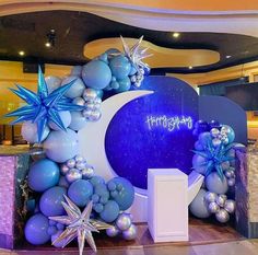 a large balloon arch decorated with stars and balloons