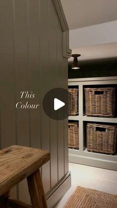 a wooden bench sitting in the middle of a room with baskets on top of it