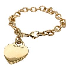 This is part of Chairish’s Fine Jewelry assortment. A very fine Tiffany Co. bracelet. In 18k gold. With slightly oval links and a heart-shaped pendant charm. The charm is not engraved. Simply wonderful, classic Tiffany design! Date: 20th Century Overall Condition: It is in overall good, as-pictured, used estate condition with some very fine light surface scratches and other signs of expected light wear consistent with age. Fineness: Marked 750 for 18k gold fineness. Marks: Tiffany Co. / Classic White Gold Jewelry With Logo Charm, Luxury Charm Bracelet With Logo Charm As Gift, Luxury Logo Charm Bracelet As Gift, Luxury Yellow Gold Charm Bracelet With Logo, Elegant Charm Bracelet With Logo Charm As Gift, Classic Bracelets With Logo Charm As A Gift, Classic Heart Charm Bracelet For Valentine's Day, Classic Gold Heart Bracelet, Luxury Yellow Gold Bracelet With Charms