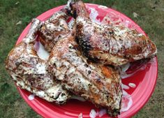 three pieces of chicken sitting on top of a red plate