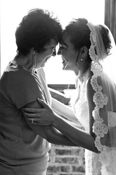 the bride and her mother share a moment together