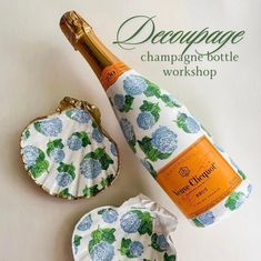 an open bottle of champagne next to a paper plate with a flower design on it