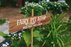 a wooden sign that says fairy pit stop where magic takes place