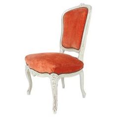 an orange chair with white trim on the back and legs, sitting in front of a white background