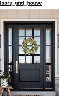 a black front door with a wreath on it