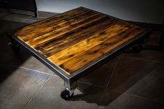 a wooden table sitting on top of a tiled floor