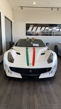 a white sports car parked in a showroom