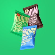 three bags of food sitting next to each other on top of a green background,