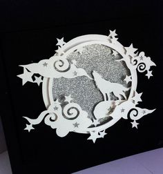 a black and white card with an image of two cats in the moon surrounded by stars