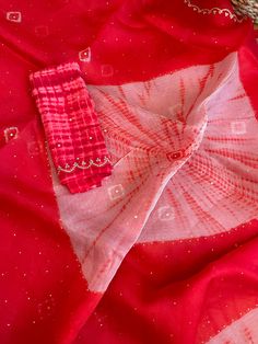 Aalna exclusive- a 100% pure organza completely hand dyed in the prettiest baby pink shade with tie-dye bandhej and shibori craft. The bandhej is done in the body and the shibori is in the palla. Both are done completely by hand. It is NOT a print. The combination of bright red and cream is stunning. After the dyeing, intricate scallop border and beautiful embroidery is done in the border as well as in the body in the bandhej butas. Micro size mirror is also hand stitched throughout the saree. I Pink Organza Dupatta For Transitional Season, Traditional Summer Organza Dupatta, Transitional Pink Organza Dupatta, Summer Bandhani Print Chanderi Dupatta, Festive Red Dupatta With Batik Print, Red Bandhani Print Dupatta For Party, Red Organza Dupatta For Transitional Season, Traditional Red Dupatta For Summer, Traditional Red Summer Dupatta