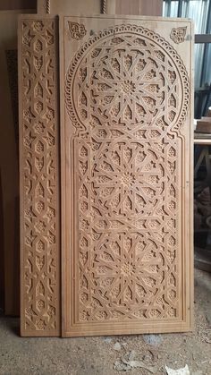 an intricately carved wooden door in the process of being made