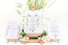 wedding stationery with flowers and cards on easel for guests to write their names