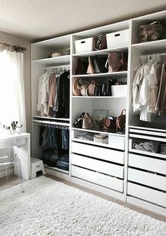 an image of a closet with clothes and other items on the shelves in front of it